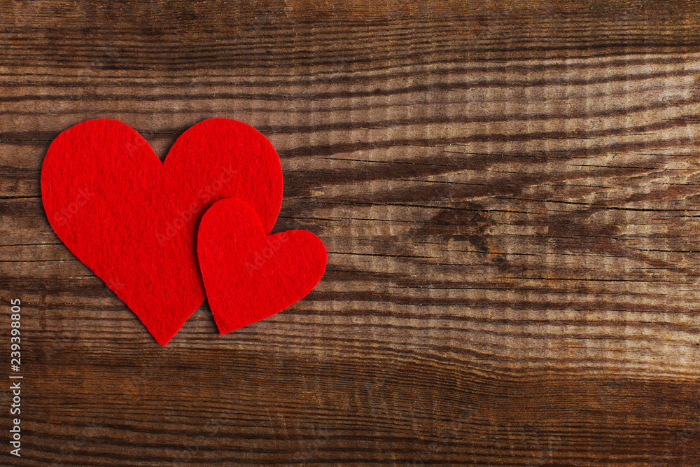 Red hearts on a wooden table. Blank or greeting card background for Valentine's Day. Place for text, copy space. Red hearts on a wooden table. Blank or greeting card background for Valentine's Day. Place for text, copy space.