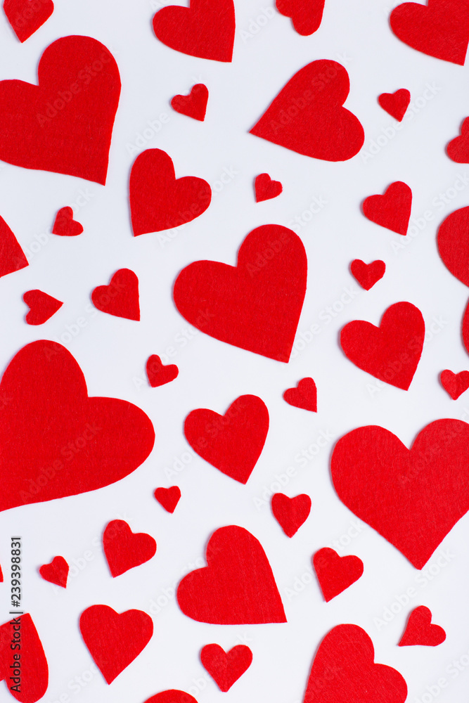 Red hearts of different sizes on a white background. Harvesting cards for Valentine's Day.