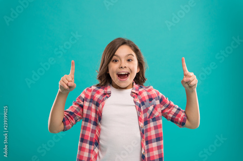 Girl cute surprised face found out important idea. Little girl long hair got bright idea. Little child smile excited with new idea stand over blue background. This is the point. Idea solution