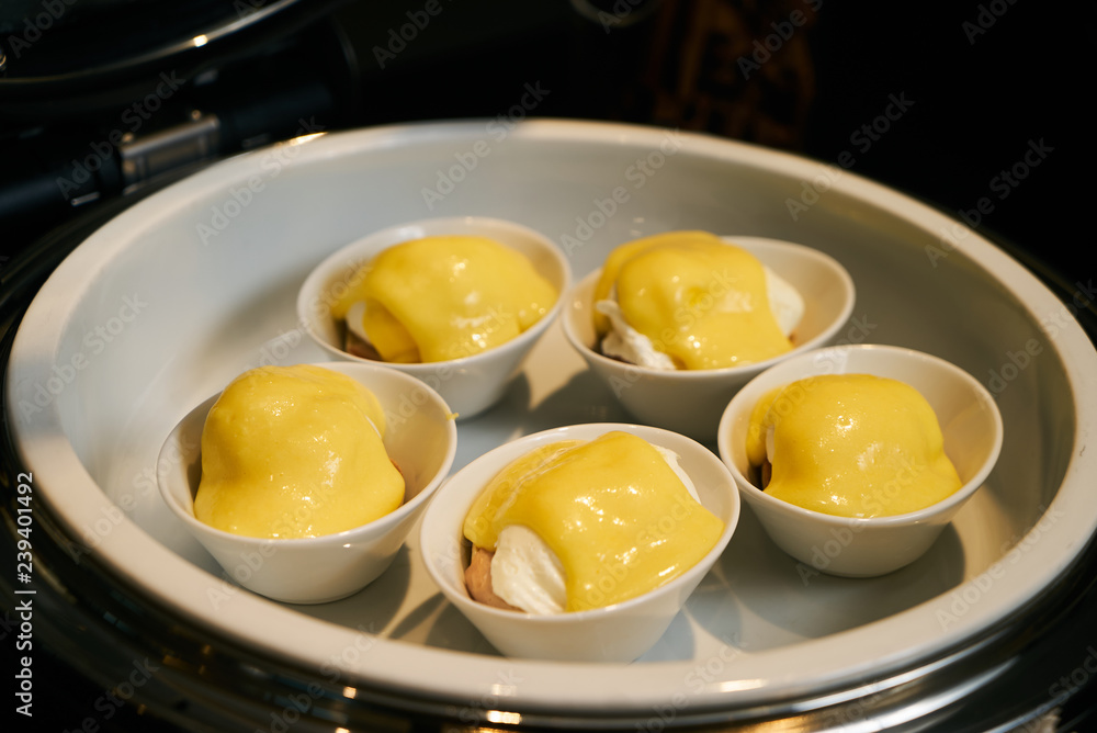 Eggs Benedict- English breakfast, close-up. Hotel restaurant buf Eggs Benedict- English breakfast, close-up. Hotel restaurant buf