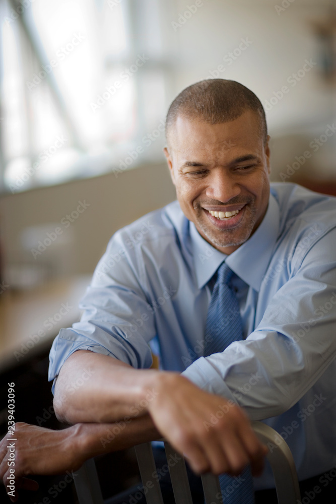 Mid-adult businessman sitting in an office. Mid-adult businessman sitting in an office.