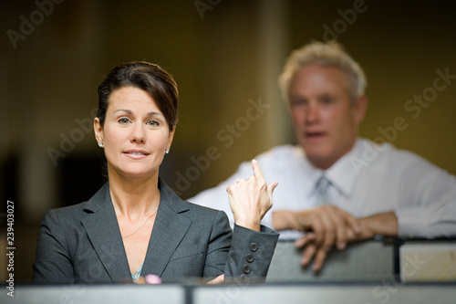 Portrait of a mid-adult business woman standing in an office cubical. photo