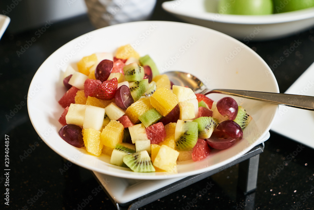 Fresh fruit salad with sliced grape, strawberry, kiwi, melon and