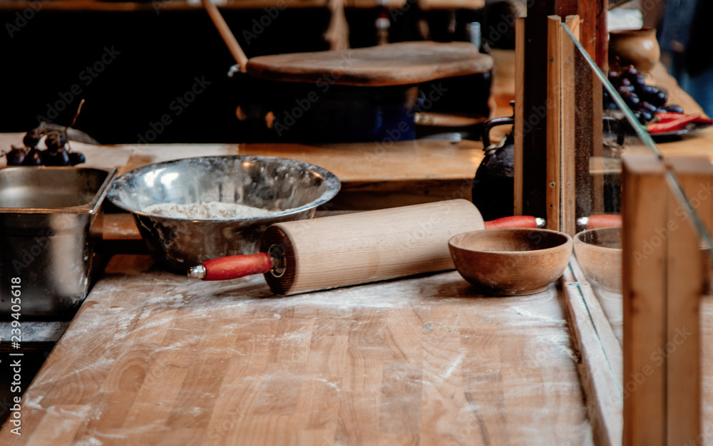 wooden dough rolling pin and flour on table at Christmas fair wooden dough rolling pin and flour on table at Christmas fair
