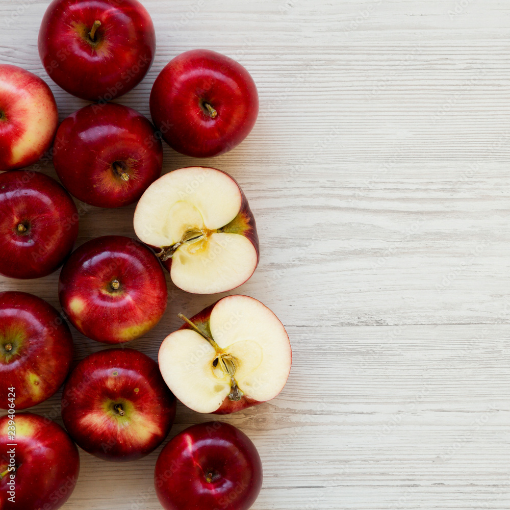 Raw red apples on white wooden background, overhead view. Flat lay, from above, top view. Copy space. Raw red apples on white wooden background, overhead view. Flat lay, from above, top view. Copy space.