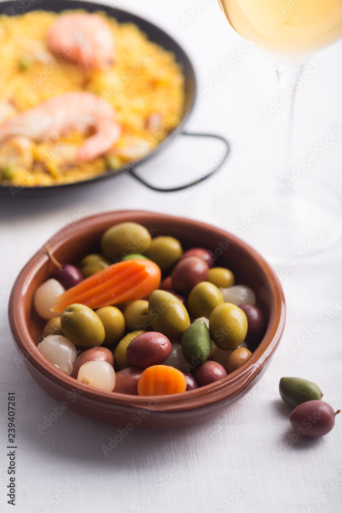 Traditional Spanish olives on the plate. Mixed with carrot and onion Traditional Spanish olives on the plate. Mixed with carrot and onion