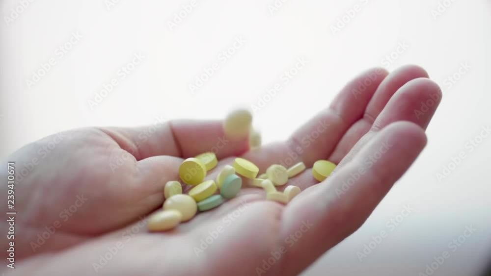 Many Different Medical Pills, Tablets, Capsules and Drugs are Falling in a Hand of Adult Man in Slow Motion Many Different Medical Pills, Tablets, Capsules and Drugs are Falling in a Hand of Adult Man in Slow Motion