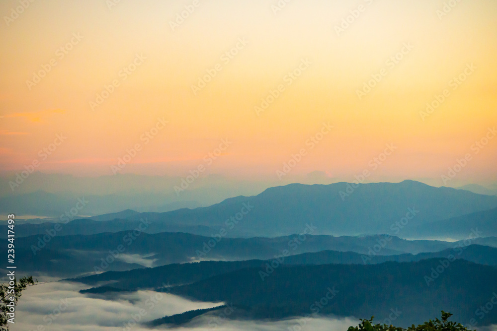  sunset overlooking mountains with Mist