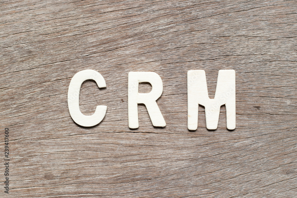 Alphabet letter in word CRM (Abbreviation of Customer Relationship Management) on wood background Alphabet letter in word CRM (Abbreviation of Customer Relationship Management) on wood background