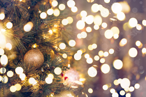 Seasonal background with Christmas toys on the tree. Celebration concept. Soft focus. Festive bold bokeh