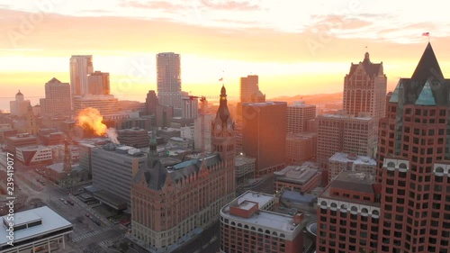 Aerial view of skyscrapers in american city at dawn. Downtown Milwaukee, Wisconsin, United States. Drone shots, sunrise, sunlight, from above.
 photo