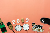Table top view of Merry Christmas decorations & Happy new year 2019 ornaments concept.Flat lay essential difference objects to party season the photo booth prob on modern pink paper background.