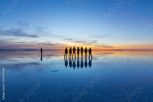 People reflections at Uyuni saltflats. One of the most amazing things that a photographer can see. The sunrise over an infinite horizon with the Uyuni salt flats making a wonderful mirror to infinity photo