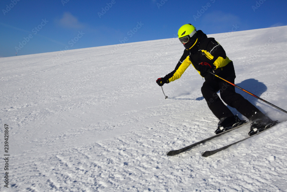 Skier skiing downhill in mountains Skier skiing downhill in mountains