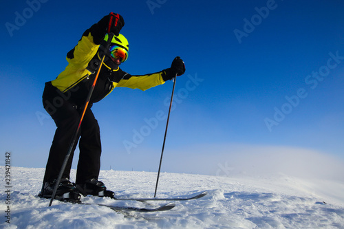 Skier skiing downhill in mountains