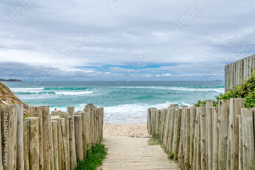 Narrow street with the sea at its end. Campeche Beach (Praia do Campeche), in Florianopolis, Brazil.