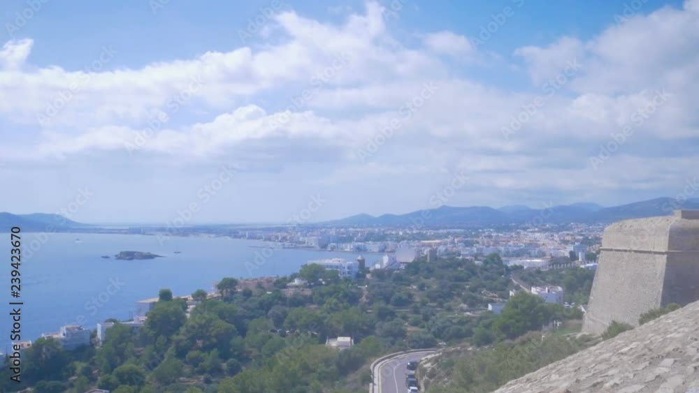 Beautiful view from the fortress in old town Dalt Vila to the port and new town in Ibiza, Spain. Blue sea and clouds in the harbor. Ibiza Town, Eivissa Beautiful view from the fortress in old town Dalt Vila to the port and new town in Ibiza, Spain. Blue sea and clouds in the harbor. Ibiza Town, Eivissa
