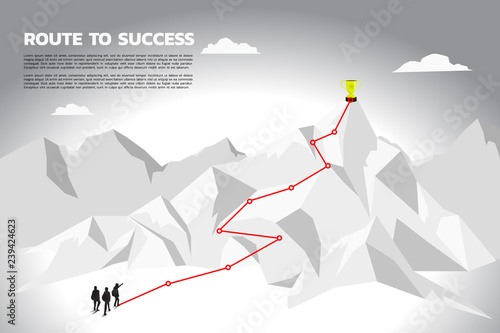 Silhouette team businessman plan to get champion trophy on top of mountain. Concept of teamwork and planning path in business
