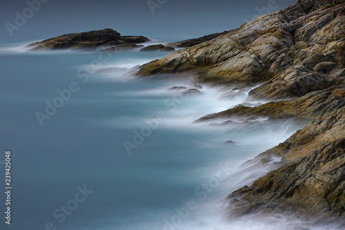 Water wave splashes and rock at Promthep cape located in Rawai, Phuket, Thailand. 