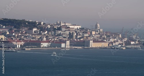 Boats arriving at Lisbon port. Beautiful cityscape in the morning. photo