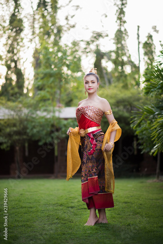 Beautiful Woman wearing typical Thai dress © Johnstocker