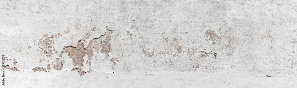 Fototapeta premium Ancient wall with peeling plaster. Old concrete wall, panoramic textured background