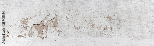 Ancient wall with peeling plaster. Old concrete wall, panoramic textured background
