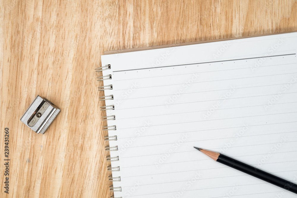 close up pencil , pencil sharpener and blank notebook on wooden background. concept of idea creative and thinking with text space close up pencil , pencil sharpener and blank notebook on wooden background. concept of idea creative and thinking with text space