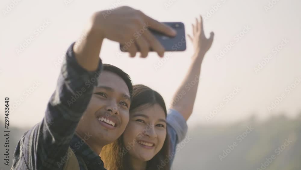 Asian couples are posing together to take photo with smartphone Asian couples are posing together to take photo with smartphone