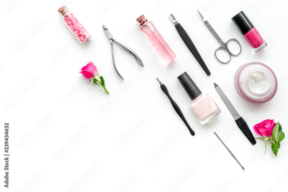 manicure equipment with nail polish and rose petals white background top view space for text