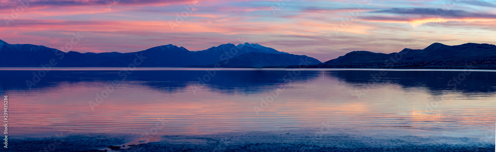 Stunning panorama of mountains reflecting off a lake