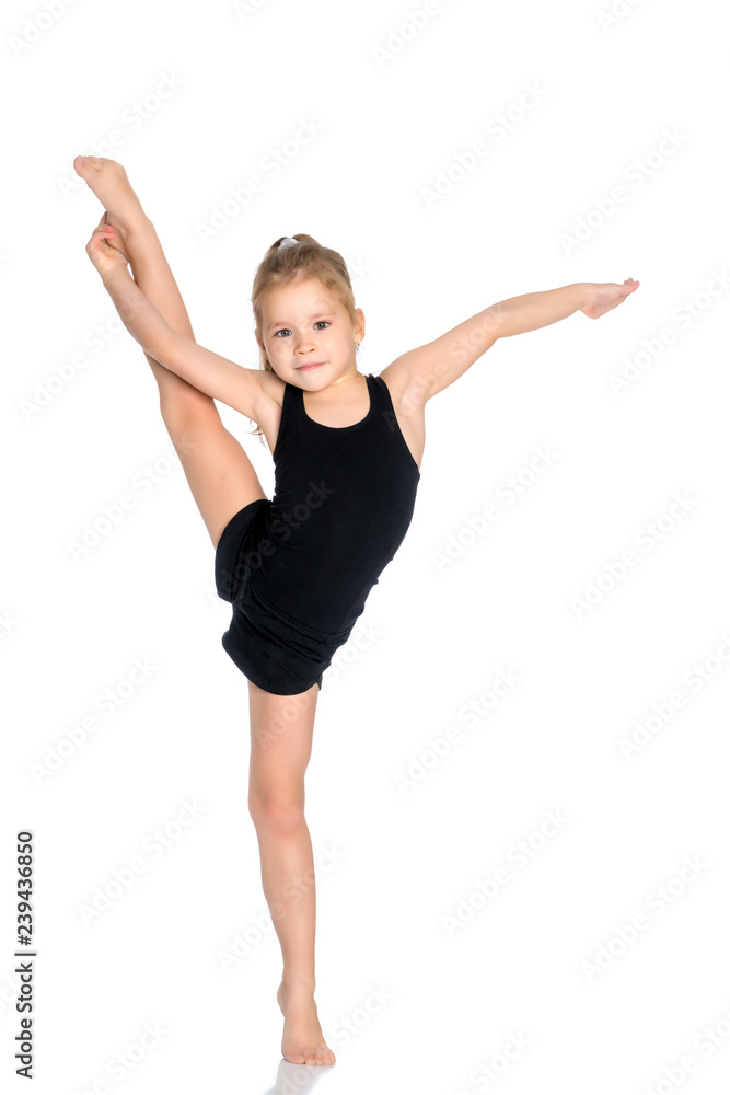 The gymnast balances on one leg. The gymnast balances on one leg.