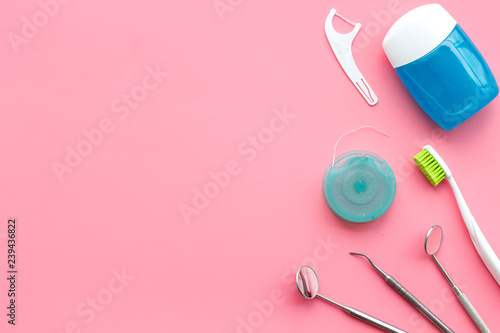 Tooth care with toothbrush, dental floss and dentist instruments. Set of cleaning products for teeth on pink background top view mockup