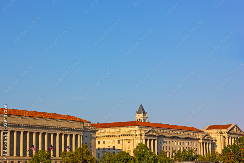 Historic architecture of Washington DC along the National Mall in summer. Buildings with columns with elaborate finishing and roofs.