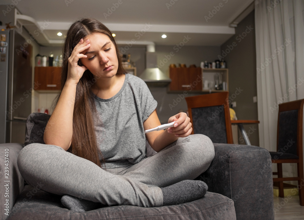 upset young woman and pregnancy test upset young woman and pregnancy test