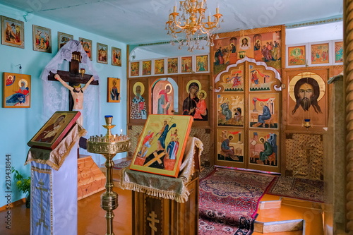 Prayer altar with handwritten icons in the interior of the village Russian church.