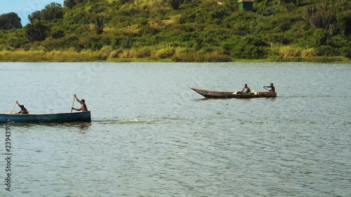 Fishermans paddling to the sea,  Lake Albert Uganda photo