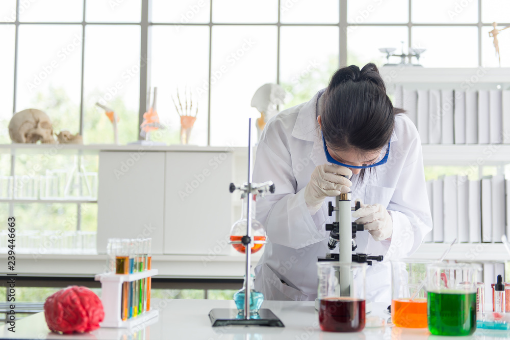 Scientist asian woman using microscope with metal lens for research,Medical equipment in laboratory Scientist asian woman using microscope with metal lens for research,Medical equipment in laboratory