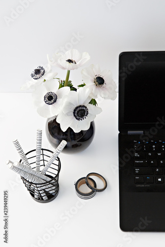 table with flowers and pen holder photo