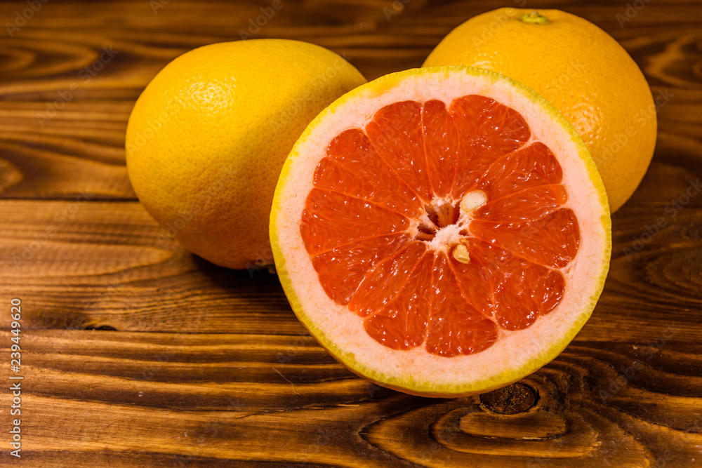 Ripe juicy grapefruit on a wooden table Ripe juicy grapefruit on a wooden table