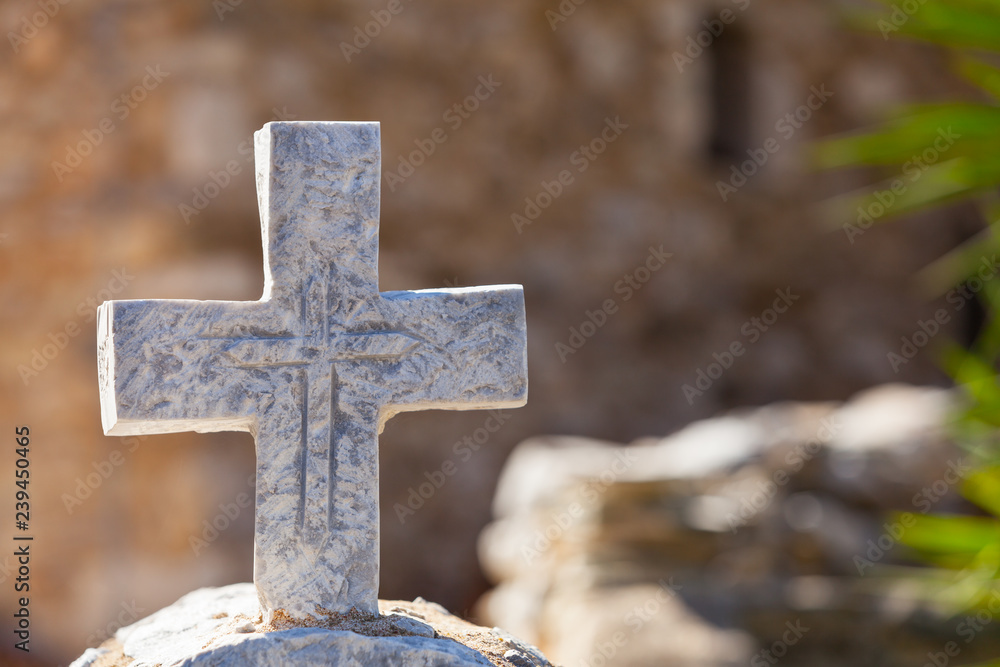 Greek stone cross on burial ground