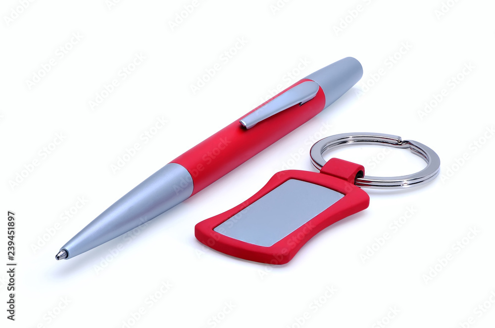 Silver-red metal pen and keychain isolated on white Silver-red metal pen and keychain isolated on white