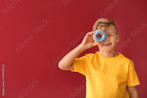 Cute little boy with donut ...