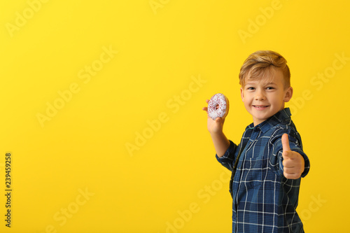 Cute little boy with donut ...