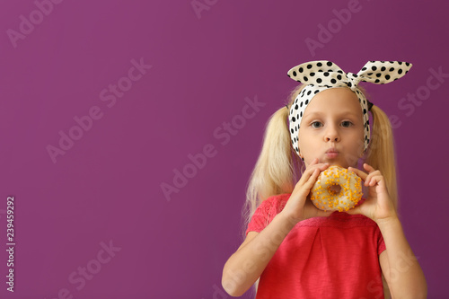 Cute little girl with donut...