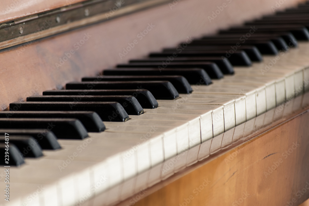 Keys of an old wooden piano. Piano keys on wooden brown musical instrument Keys of an old wooden piano. Piano keys on wooden brown musical instrument
