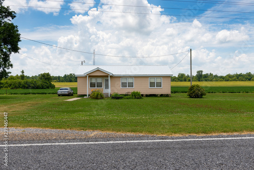 A mobile home with a car parked on the driveway in a rural area of the State of Mississippi, near the Mississippi river, USA.