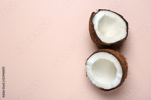Cut ripe coconut on color background