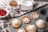 Baking tray with tasty mince pies on table