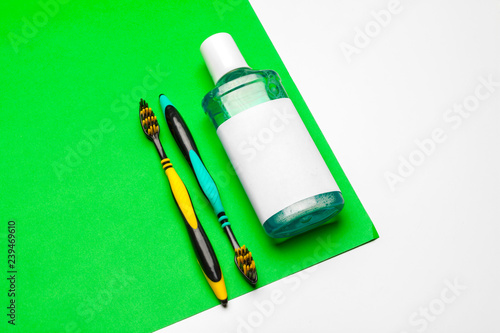 Flat lay composition with manual toothbrushes and oral hygiene product